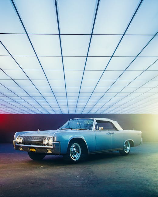 A vintage classic car displayed indoors with modern lighting, showcasing style and elegance.